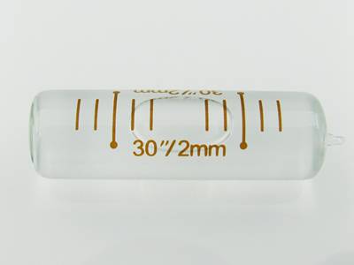 There is a transparent glass tubular spirit level vial of high precision on the ground.